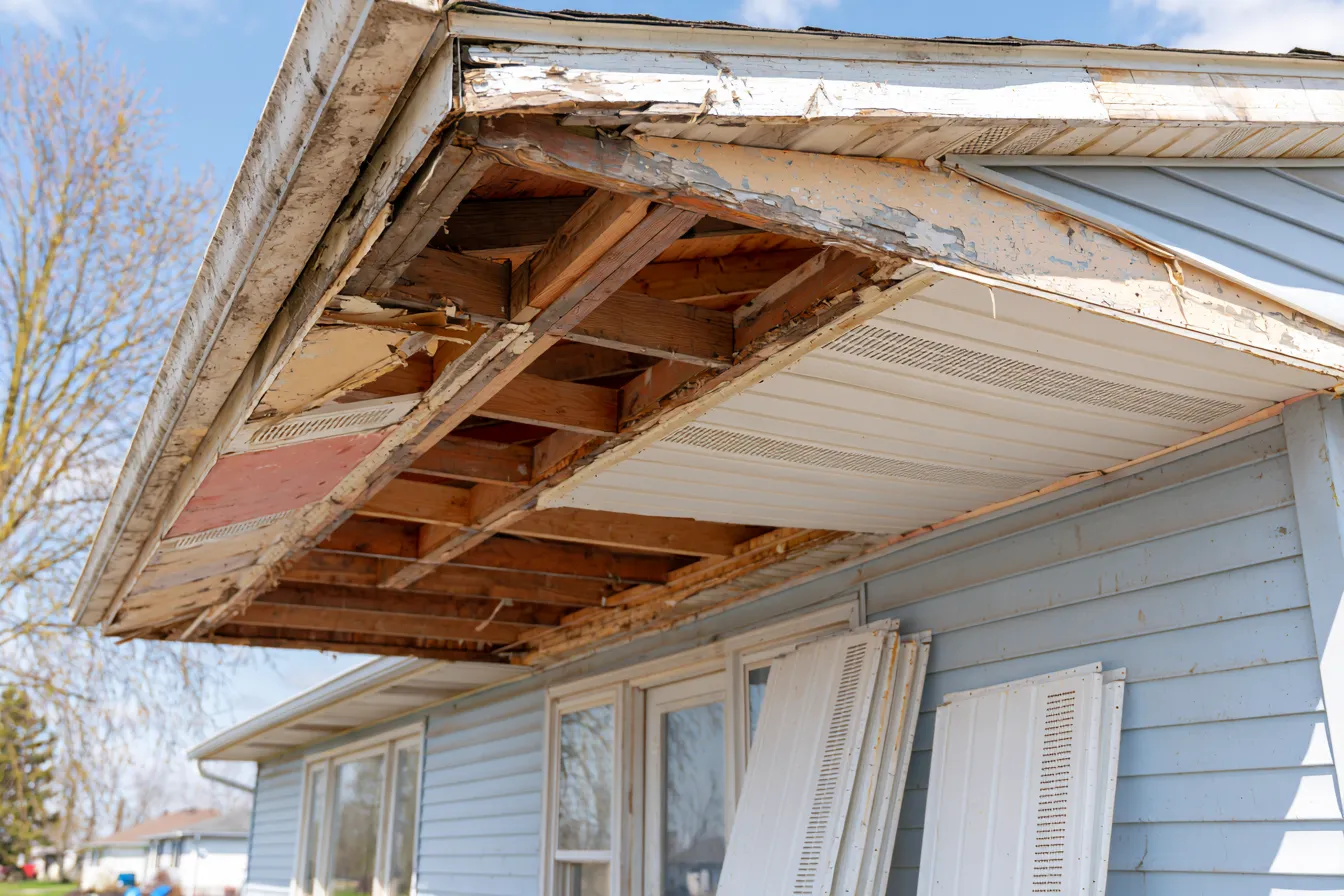 Eave with soffit panels removed mid-replacement