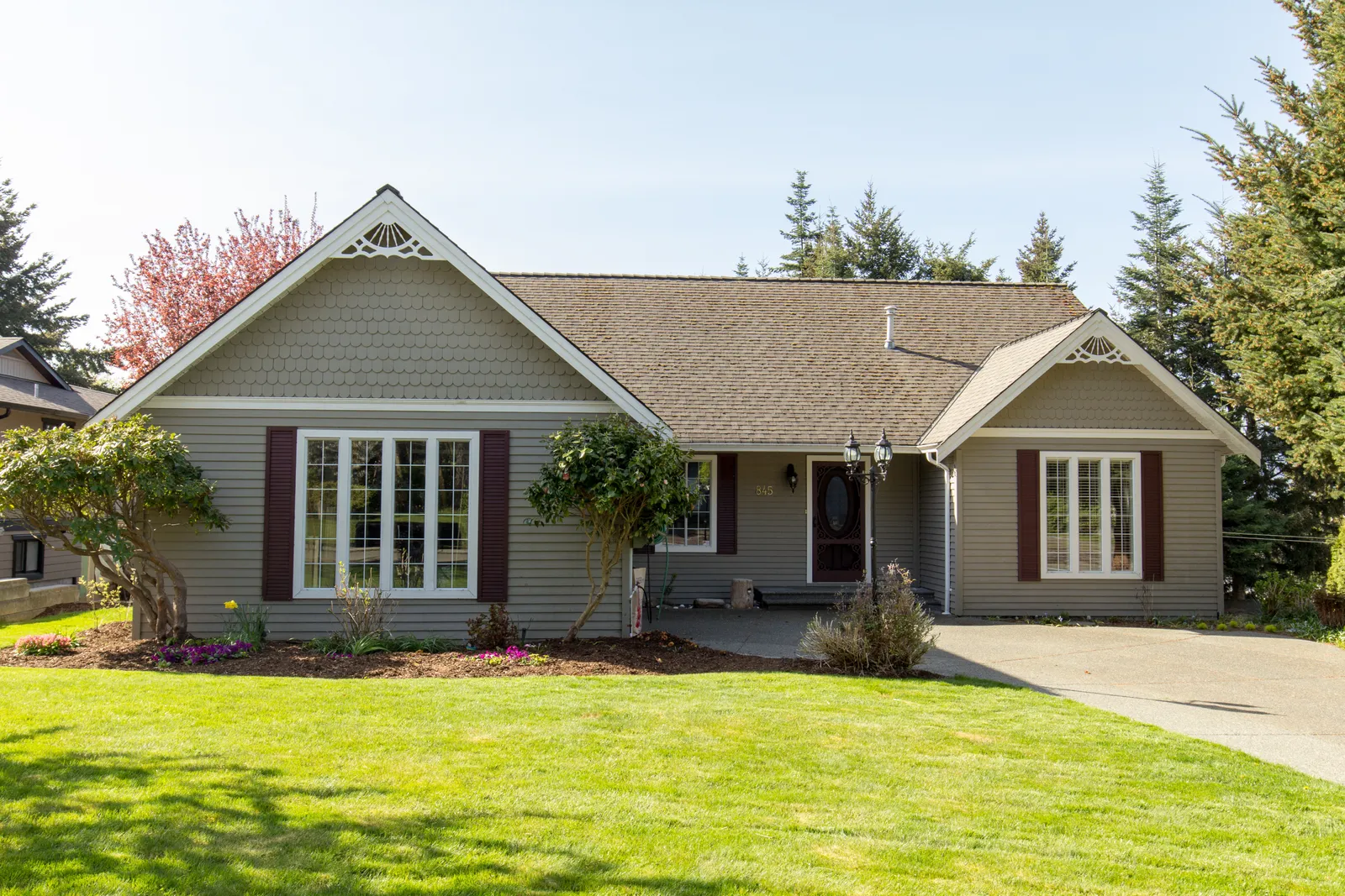 Decorative gable trim on a single-story home under a brown shingle roof